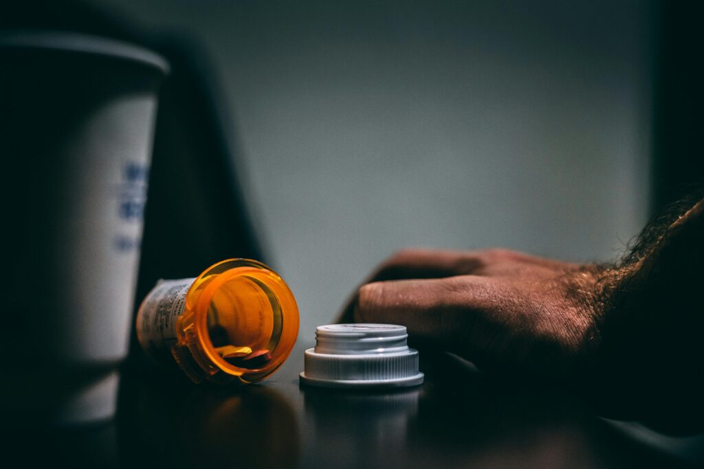 Empty prescription bottles on a counter representing the 1.3 million Americans rationing insulin and the one in five Americans who did not fill a prescription last year because they could not afford the cost
