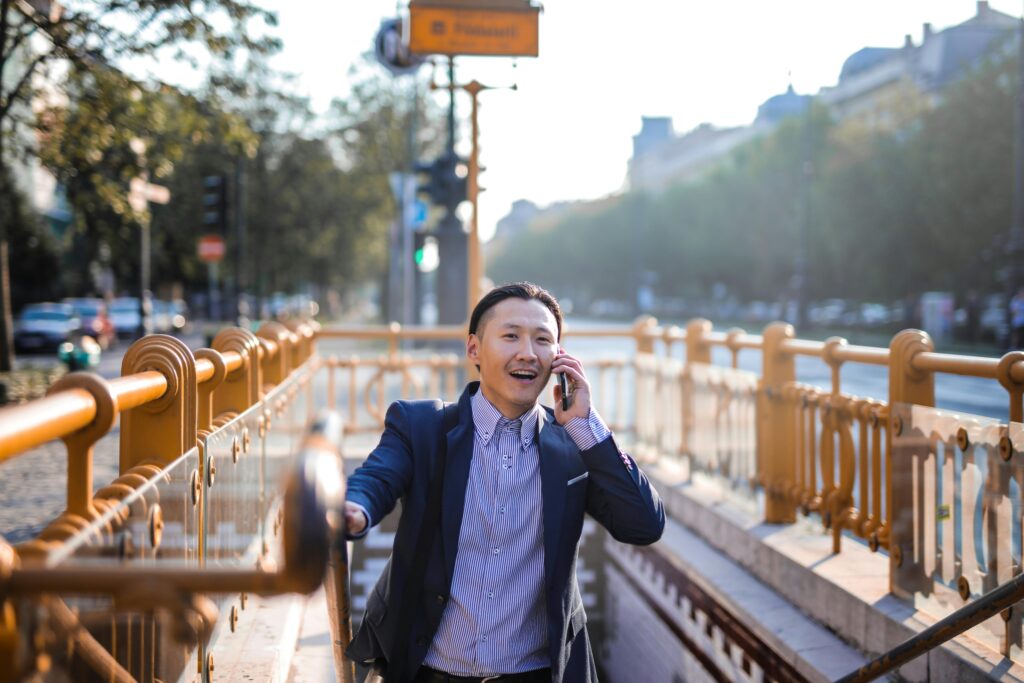 Young man smiling during phone call representing reconnecting with friends and fighting loneliness