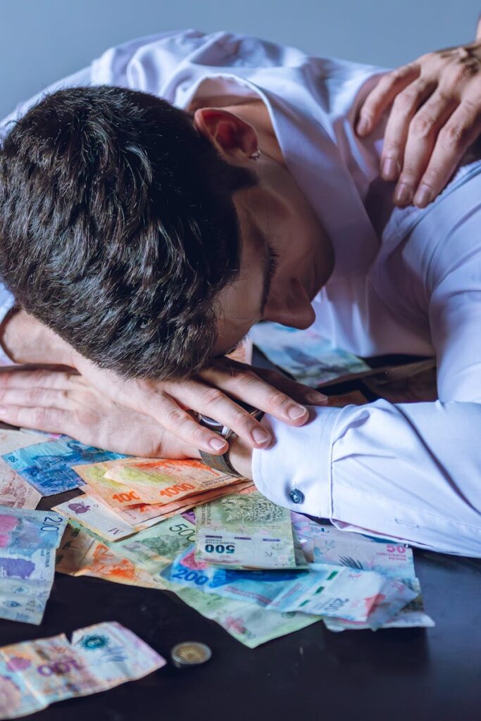 Older American worker reviewing 401k retirement account paperwork with concern, representing the record rise in hardship withdrawals in 2025 as financial pressure forces workers to raid retirement savings.