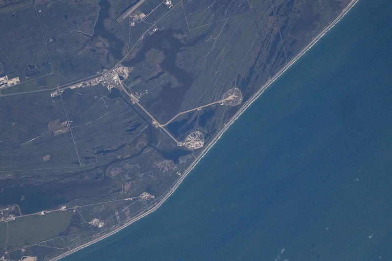 Aerial view of NASA's Kennedy Space Center from the International Space Station showing the Artemis II rocket on Launch Pad 39B, photographed from 258 miles above Earth on January 20, 2026