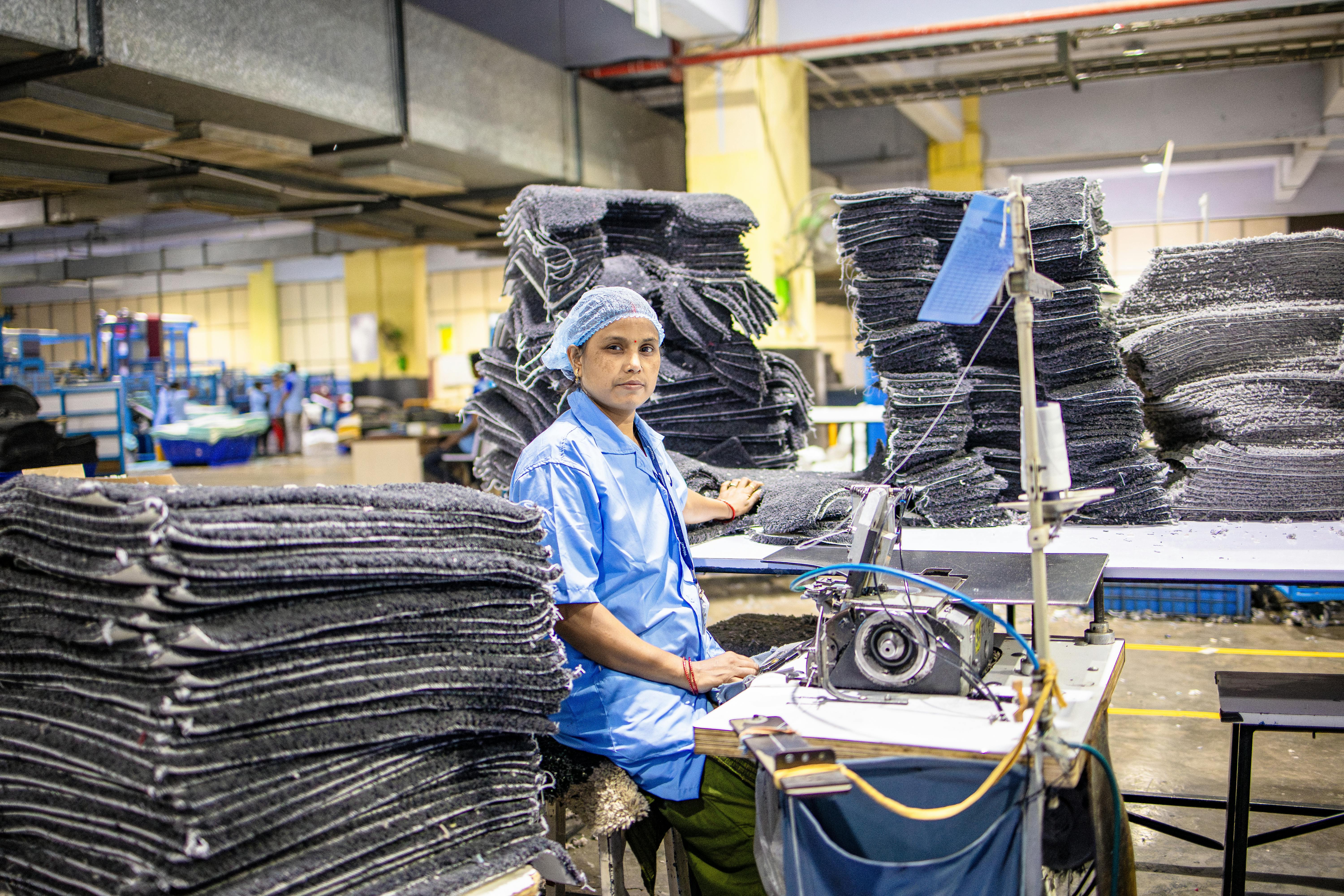 An American manufacturing factory floor showing industrial equipment and workers, representing the 89,000 manufacturing jobs lost since Liberation Day tariffs were announced in April 2025