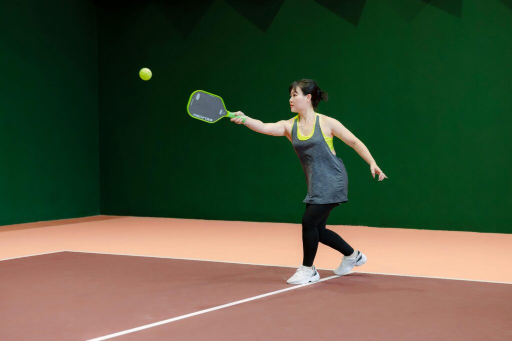 Senior woman playing pickleball comfortably showing low impact exercise benefits for joints