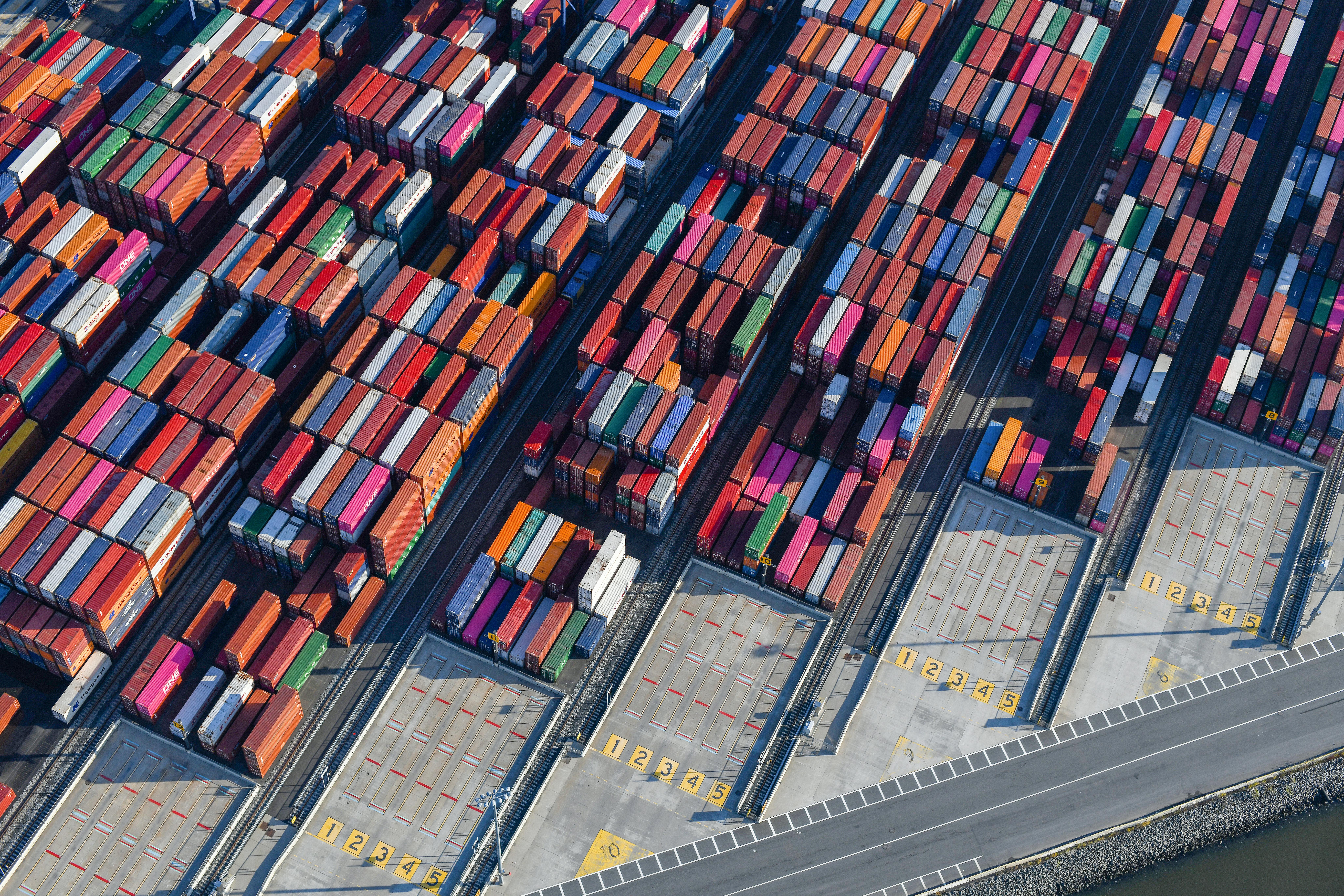 Stacked shipping containers at the Port of Los Angeles, representing billions of dollars in U.S. imports affected by Liberation Day tariff policies in 2025 and 2026