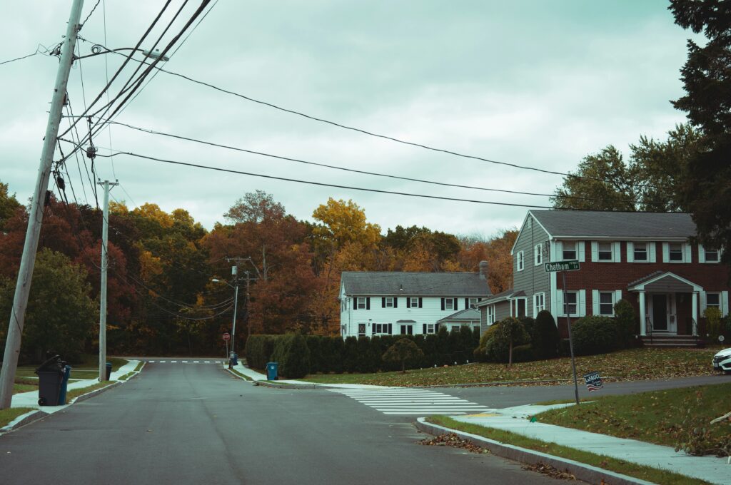 Quiet suburban neighborhood in a mid-sized American town with tree-lined streets and affordable homes