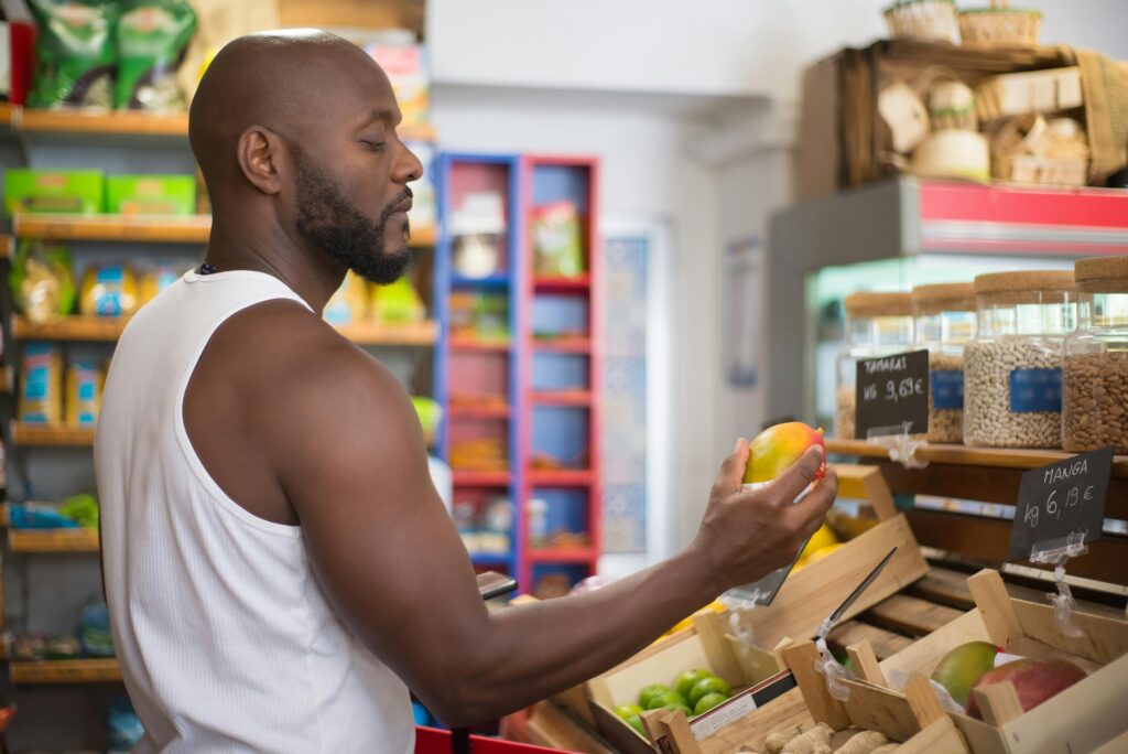 American grocery store shelves with visible price tags showing rising food costs, reflecting the delayed impact of 2025 Liberation Day tariffs hitting consumers in 2026